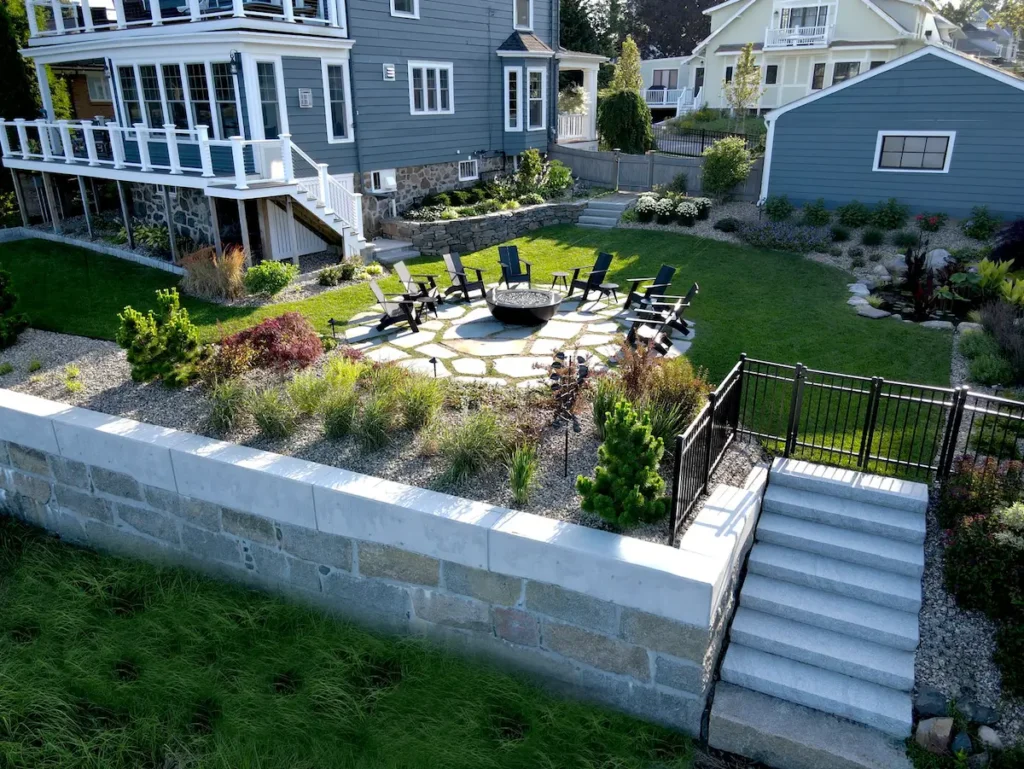 Fire pit and stone patio design, with a stone staircase and retaining wall.