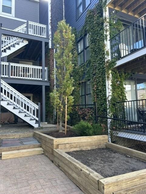 Multi-level garden beds with a new tree planted by Leahy Landscaping